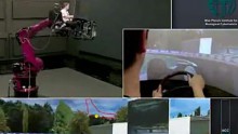 Roboterarm bewegt sich synchronisiert mit einem Formel-1-Spiel